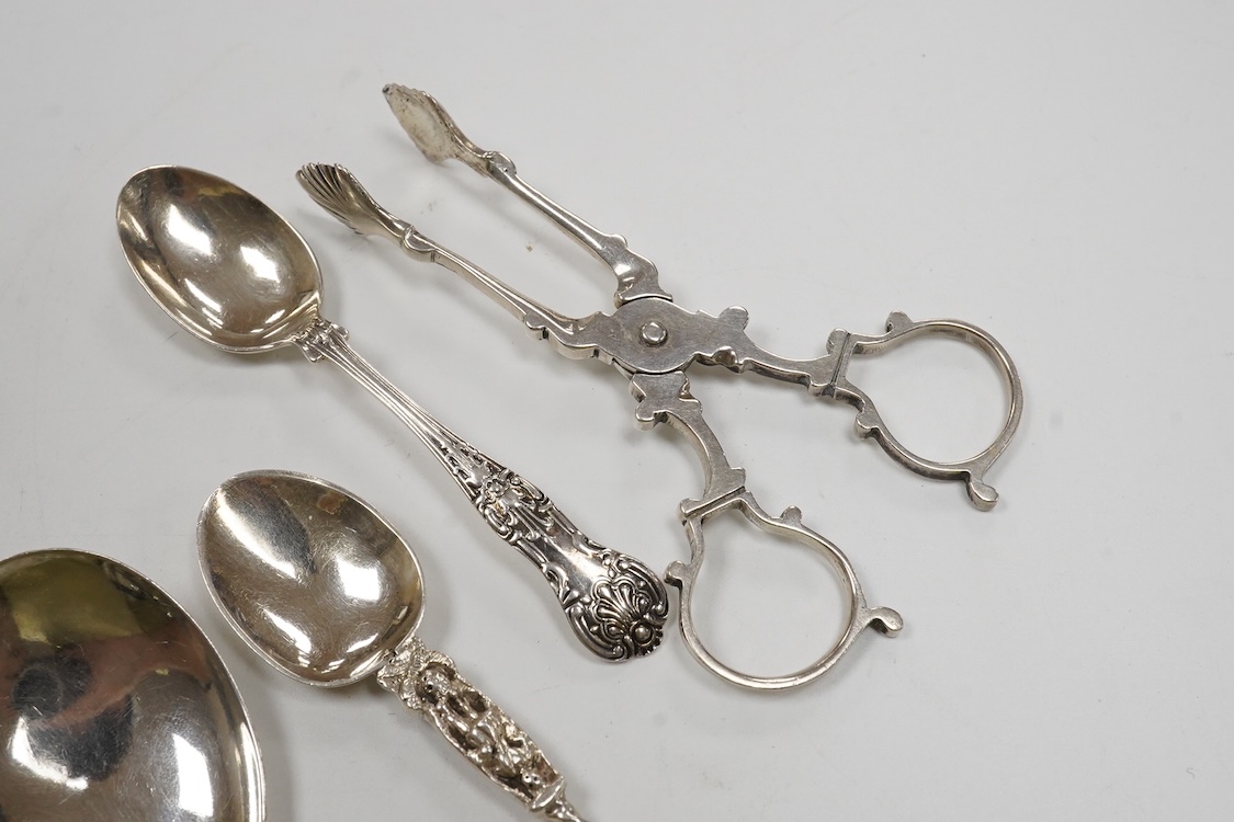Two 19th century silver caddy spoons including Reid & Sons, Newcastle, 1837, ten assorted silver coffee spoons including apostle and a pair of George V silver sugar nips by William Hutton & Sons, 4.8oz.